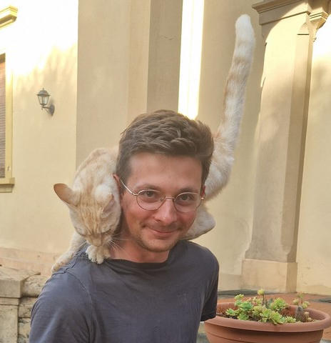 Sam Goldstein with a cat on his shoulder